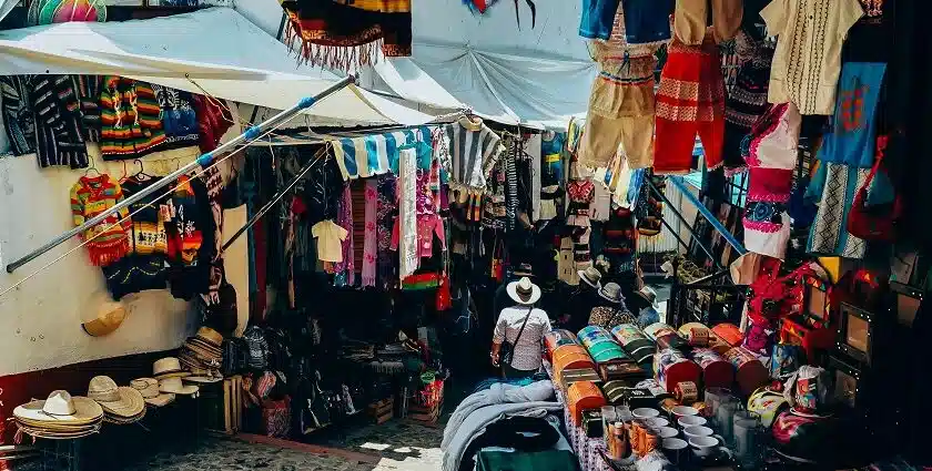Vibrant street market in Kodaikanal selling colorful woolen clothes, traditional hats and local handicraft souvenirs.